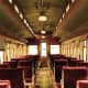 Finding a seat in the Passenger Car: "All Aboard for the Journey."