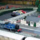 Carpark by the railway station in a model railway layout.