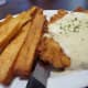 Chicken fried steak with country gravy and a side of french fries