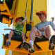 Kids use a pulley to climb to the top of the Kid Power Towers in Fun Town.