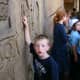 The author's son looks at the side of an &quot;Egyptian ruin&quot; while waiting in line for the Lost Kingdom ride.