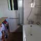 Bathroom after the walls were repainted; a colour change from pink to green.