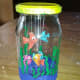 Make a dry aquarium in a recycled pickle jar.