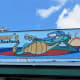 A whimsical exterior sign with an alligator at Benno's Cajun Seafood Restaurant