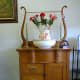 Oak washstand from the 1860s with a bowl and pitcher set and an old iron