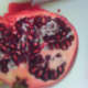 Pomegranate seeds nestled in the pulp.