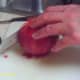 Slice the pomegranate in half to obtain the seeds.