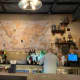 The map behind the bar really has an early 1940s feel to it. If you look closely you can see the flight paths the plane took. I love the look of all the bottles.