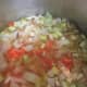 Cooking the vegetables in chicken broth until tender