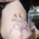 Dandelion tattoo on side of torso