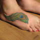 Peacock feather foot tattoo