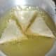When the edges start browning, flip the samosas.