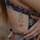 Sun, moon, and eye tattoo on side ribs