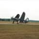 An SB2C Helldiver with taxiing with folded wings.