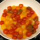 Sweat cherry tomatoes in skillet