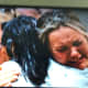 Photo of families consoling each other after the mass school shooting in Uvalde, Texas.