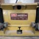 The bench grinder used to round off the ends of the cut wire