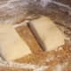 Place chilled square dough on floured surface. Cut in half. Put one half back into the refrigerator.
