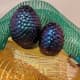 The angle you're looking at these changes dramatically based on the angle. The large egg is a green/purple mix, the smaller is blue/purple