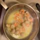 The shrimp turn pink and curl inward and the scallops go from translucent to white and become more firm. Remember, do not over cook the seafood or it will become rubbery.