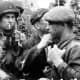 A member of the American 82nd Airborne division meets with members of the French resistance on D-Day.