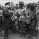 General Dwight D. Eisenhower speaking with First lieutenant Wallace C. Strobel and men of Company E, 2nd Battalion, 502nd Parachute Infantry Regiment of the 101st Airborne Division  on June 5, 1944. The would be the first to drop onto Normandy.