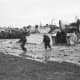 British troops come ashore at Jig Green sector, Gold Beach under light enemy fire.