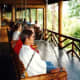 People were seated on the rustic porch of Grand Lake Lodge.