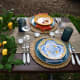 For an additional $60, you can upgrade the centerpiece for a square navy runner, a cutting board, a cheese knife set, a faux lemon garland, and two Quinn Crystal compotes. The lemon garland is featured in this picture.
