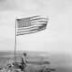 U.S. flag over Mount Suribachi on the fourth day of the battle, but the bloodiest part of the battle for Iwo Jima was yet ahead for the Americans. 