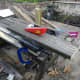 Cutting a piece of salvaged decking into battens for underpinning the decking seats.