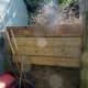 Extra decking added to the compost bin; using a piece of salvaged decking.