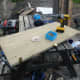 Fitting the hinges to the folding table top made from decking offcuts.