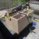 Turning the box unit over to finish securing with screws.
