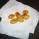 Roast potatoes are drained on kitchen paper