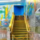 Brass staircase and murals.