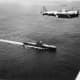 An SBD flies over Enterprise. The carrier Saratoga is in the distant background near the top of the photo. At Midway the Dauntless accounted for all Japanese loses.
