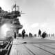 Smoke pours from USS Yorktown after being hit in the boilers by Japanese dive bombers at Midway. Soon she would find the bottom of the sea.