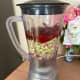 In a blender, combine the shallots, ginger, lemongrass, dried red chiles, garlic, turmeric, and water.