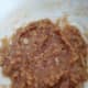The minced ginger, garlic, sesame oil, soy sauce, vinegar, and peanut butter paste. For a watery paste, you may add in lemon juice to make it easier to mix the noodles with