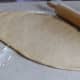 You want to roll that dough out long the first time. Not rolling it long enough is going to make it harder down the line when you have more rolling and folding to do.
