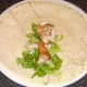 Salad and chicken meat laid on wrap