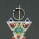The triangular shaped jewellery with blue, green, red and yellow is recognisably Kabyle. Traditionally the red would be genuine coral.