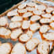 Transfer the sliced baguette to a baking tray.
