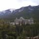 A distant shot of the Fairmont Banff Springs Hotel nestled into the Rocky Mountains. 