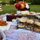 For a stunning picnic, select a beautiful quilt. Add a vase of flowers. Wire racks are great for finger foods.