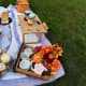 The picnic table can also be converted into a charcuterie board. The legs can be folded underneath the table.