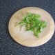 Fresh rocket/arugula is chopped to garnish the casserole