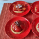 Strawberry Tartlets with brown and white chocolate decorations.