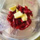 Add the red chilies and garlic into the blender. Don't forget to add water before blending. 